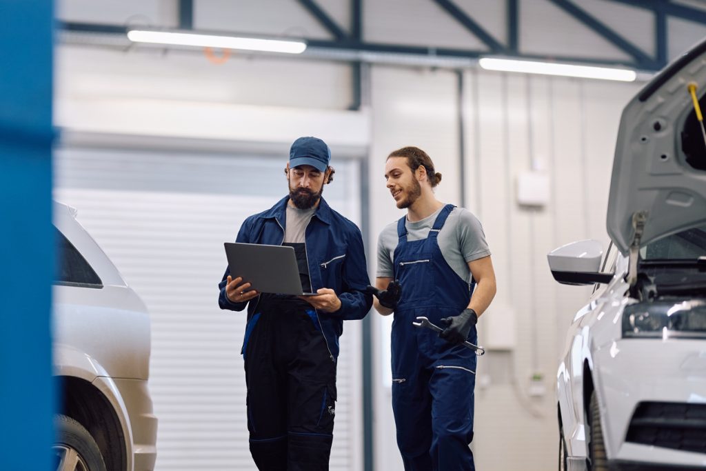 Shop employees reviewing technician capacity and scheduled work