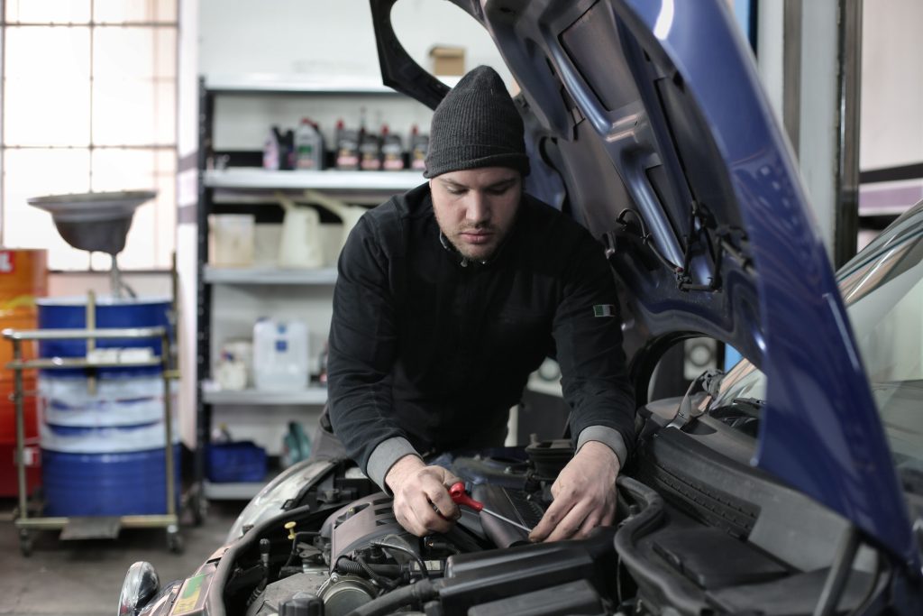 Automotive technician working on a vehicle in a repair shop