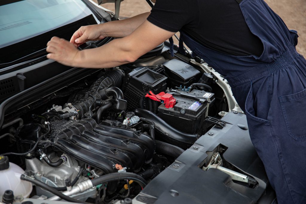 Technician inspecting a vehicle during the auto repair process.
