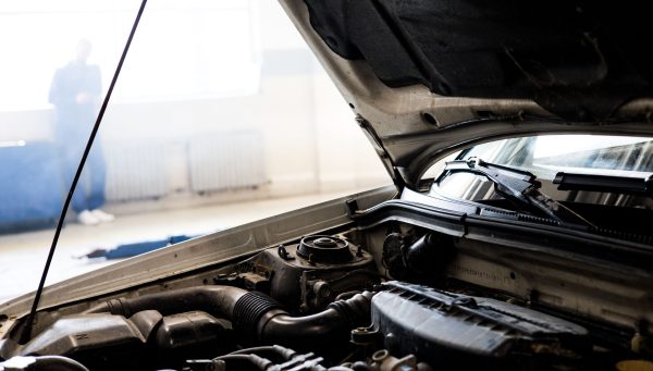 Auto repair technician completing vehicle service to ensure accurate invoicing {{brizy_dc_image_alt imageSrc=