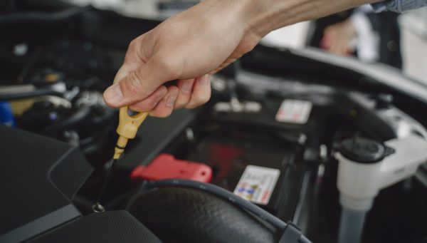 Auto repair technician working within a connected shop management system {{brizy_dc_image_alt imageSrc=