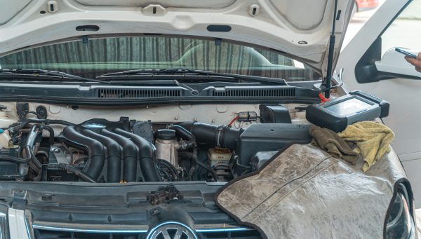 Auto repair technician completing vehicle service to improve shop productivity {{brizy_dc_image_alt imageSrc=