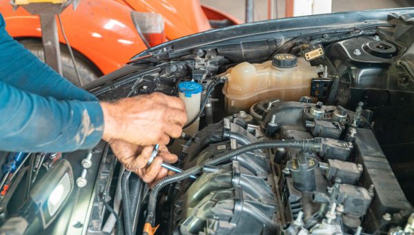 Auto repair technician performing approved repair work to keep bays productive {{brizy_dc_image_alt imageSrc=