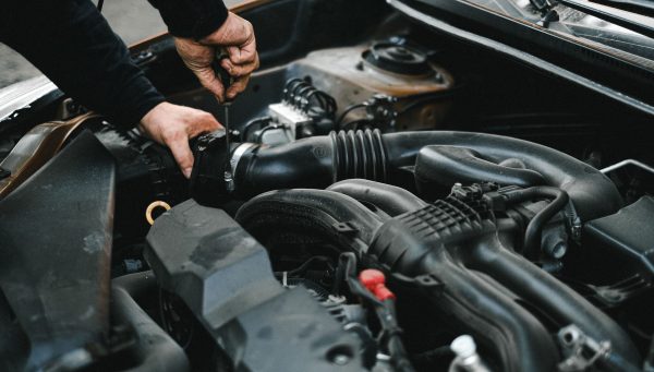 Auto repair technician documenting vehicle inspection findings for future service opportunities